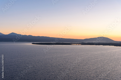 the endless expanses of Lake Sevan in the golden season, in the light of the setting sun, in the autumn yellow-golden brown color. © StockAleksey