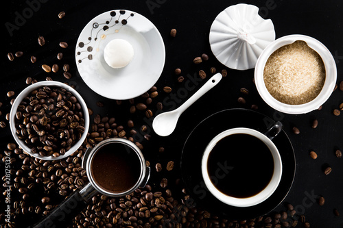 Coffee scene flat lay beans porta filter black coffee cup sugar and macaroon biscuit