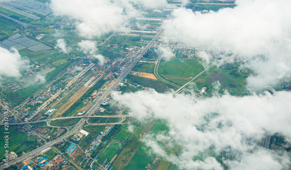 Top view landscape city sea mountain below over clouds