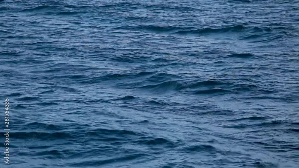 Video background of dark blue aqua sea water surface splashing outside. Real time full hd footage. Video background of dark blue aqua sea water surface splashing outside. Real time full hd footage.