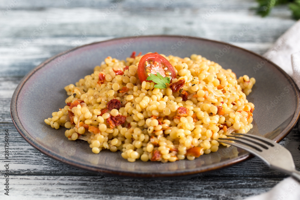Ptitim or Birdy, Israeli pasta couscous with tomatoes and herbs Ptitim or Birdy, Israeli pasta couscous with tomatoes and herbs
