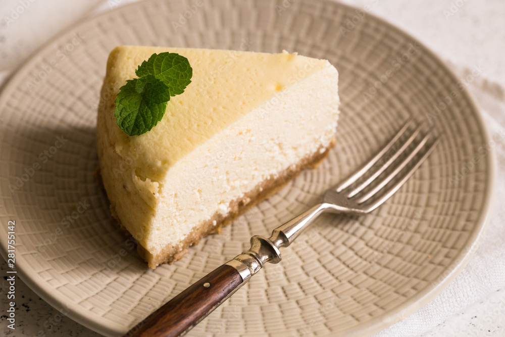 Slice Of Classical New York Cheesecake On White Plate. Closeup View. Home bakery concept Slice Of Classical New York Cheesecake On White Plate. Closeup View. Home bakery concept