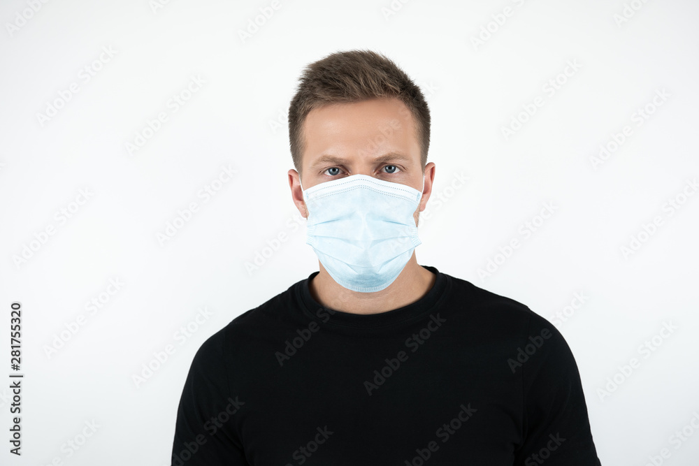 handsome young man in black t-shirt wearing medical mask on isolated white background handsome young man in black t-shirt wearing medical mask on isolated white background