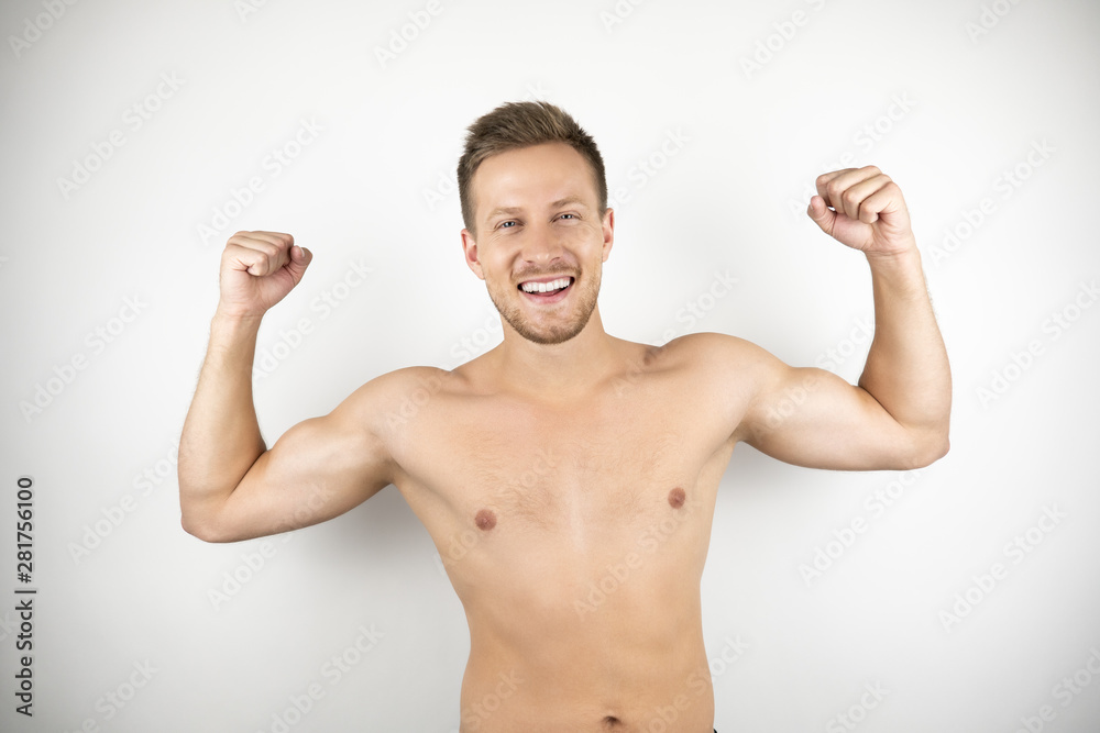 image of handsome strong smiling man with naked torso showing muscles white isolated background image of handsome strong smiling man with naked torso showing muscles white isolated background