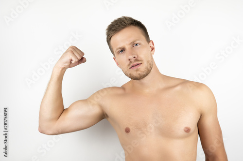 image of handsome fit man with naked torso showing pumped biceps muscles white isolated background