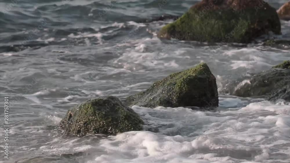 Sea waves crashing to rocks. Splashing foam in afternoon time. Sea waves crashing to rocks. Splashing foam in afternoon time.