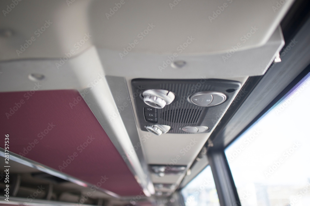 Row of air conditioning system in shuttle bus, making cool fresh air all inside the bus, soft focus Row of air conditioning system in shuttle bus, making cool fresh air all inside the bus, soft focus