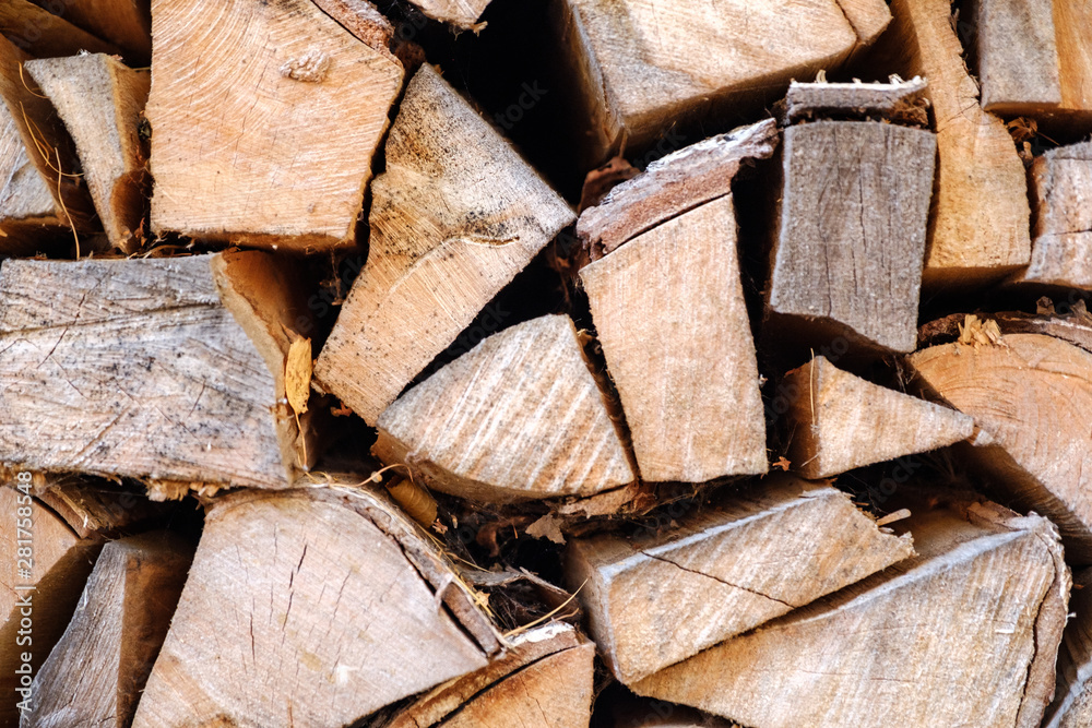 Background of chopped, sawn and stabbed stacked wooden logs. Background of chopped, sawn and stabbed stacked wooden logs.