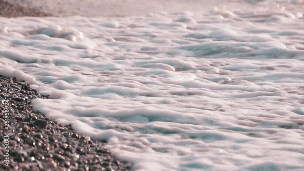 Sea waves on shore, beach. Washed ashore water and foam with sand. Summer concept. Sea waves on shore, beach. Washed ashore water and foam with sand. Summer concept.