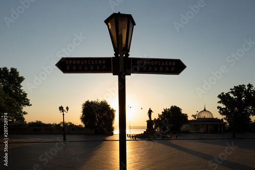 Ukraine, Odessa, Primorsky Boulevard, 13th of June 2019. Signpost and statue of Duke Richelieu at the top of the Potemkin Stairs at dawn.