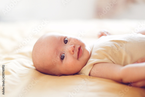 4 month baby on bed in bedroom in bright interior