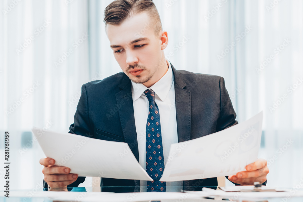 Office routine. Portrait of successful executive manager working with documents.