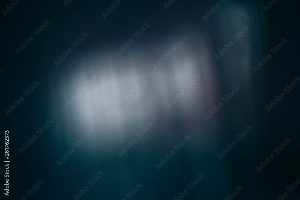 Smeared white light reflection. Teal blue abstract art background. Blur lens flare.