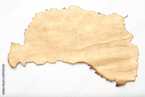 Aged beige paper with burnt edge on white background. Grunge abstract design. Copy space.