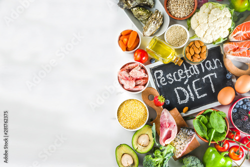 Pescetarian diet plan ingredients  healthy balanced grocery food  fresh fruit  berries  fish and shellfish clams  white marble background copy space 