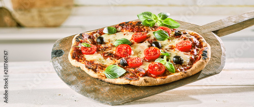 Margherita pizza with tomato, olives and basil