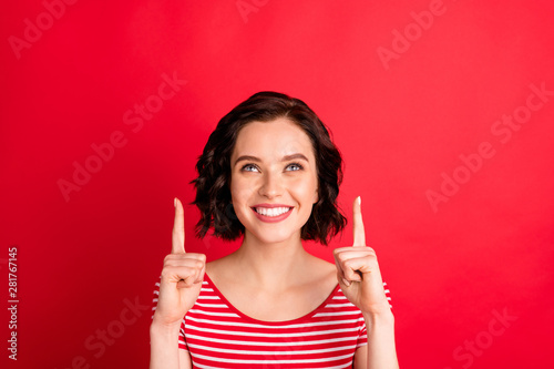 Close-up portrait of her she nice-looking attractive lovely cheerful cheery glad content wavy-haired lady pointing two forefingers up cool ad advert isolated over bright vivid shine red background photo