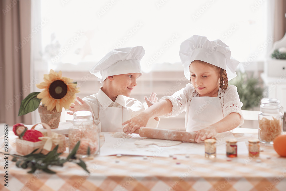 little brother and sister prepare lunch in the home kitchen little brother and sister prepare lunch in the home kitchen