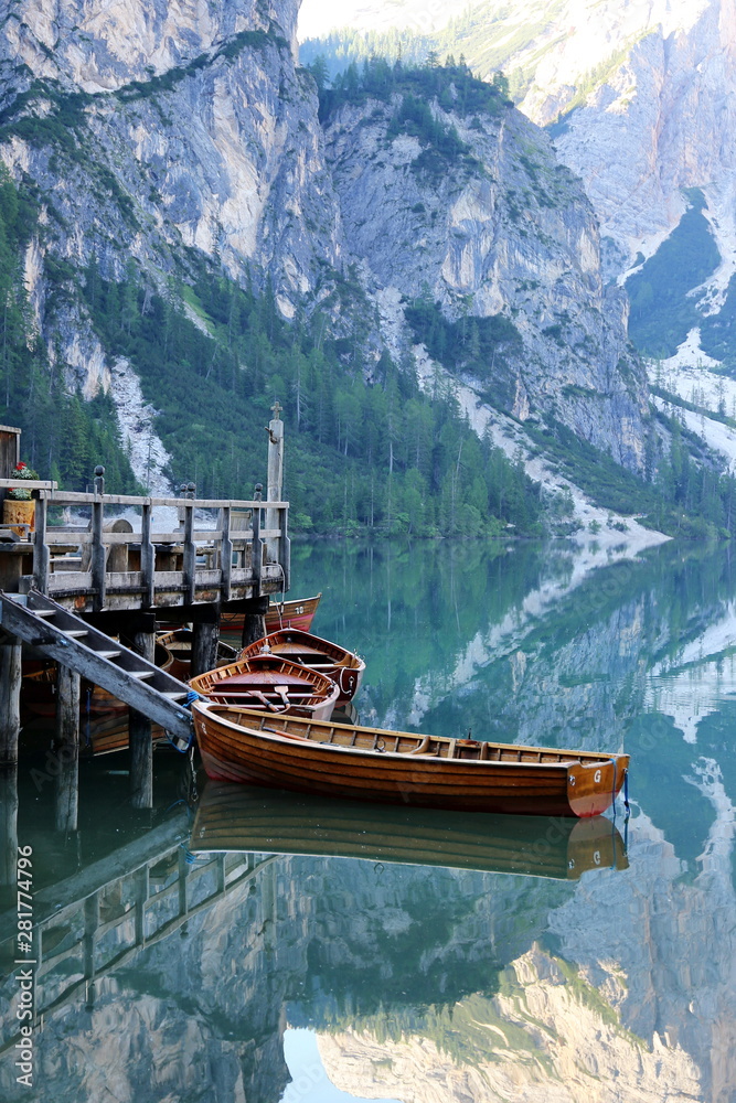 village house and boats on lake smooth as lake braies italy