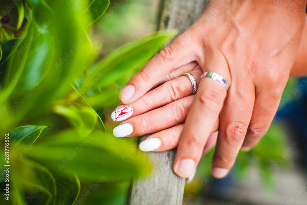 Fototapeta premium Hands of newlyweds with rings
