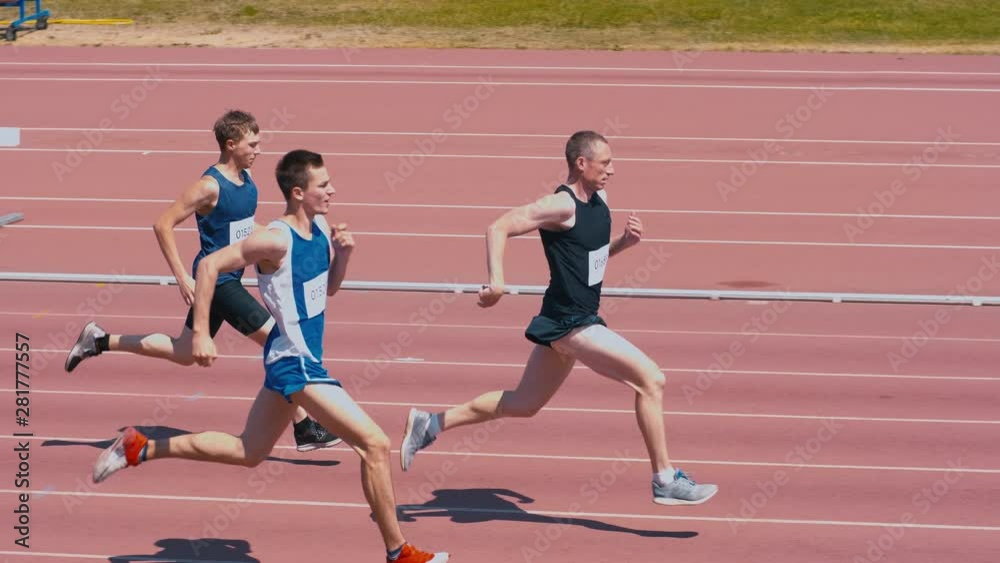 High-angle shot of professional track athletes running on outdoor track arena