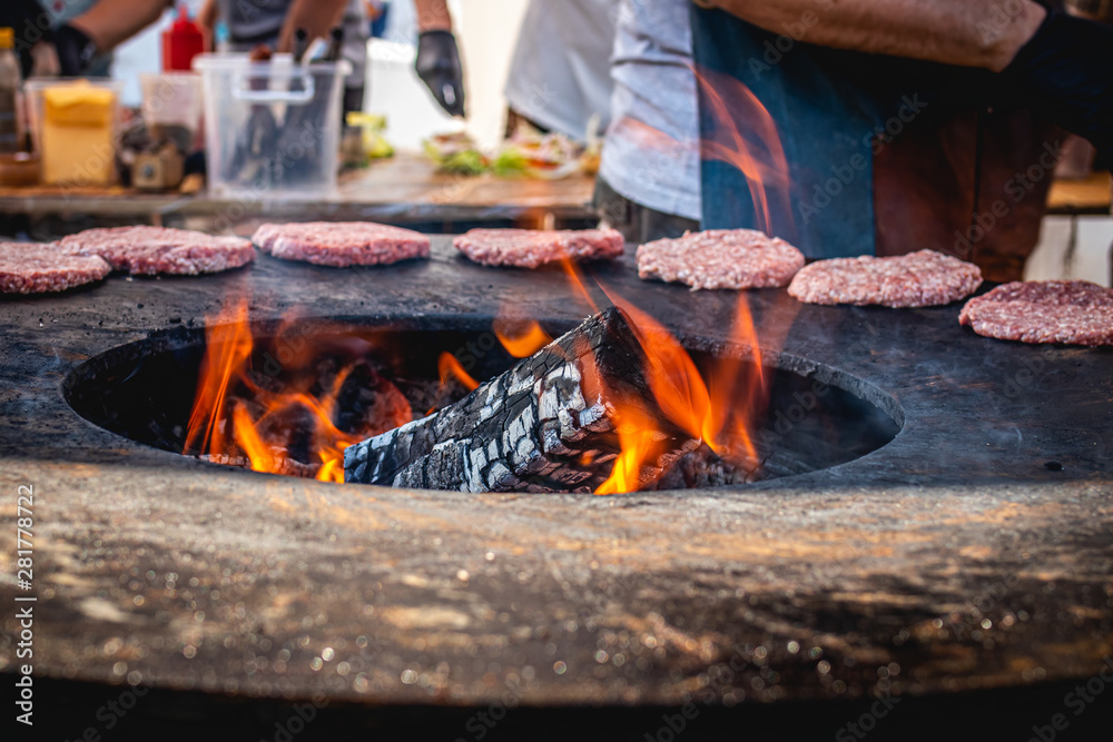 Closeup of grilled burger cutlets. Burger barbeque. BBQ, grilling, fire.