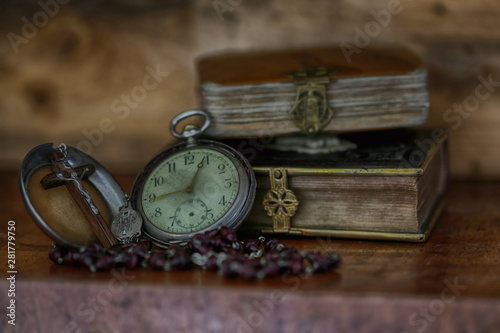 ancient bibles with pocket watch.