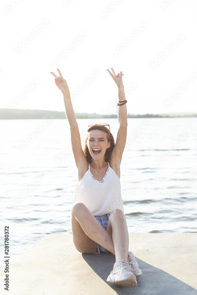 Front view carefree woman posing on dock Front view carefree woman posing on dock