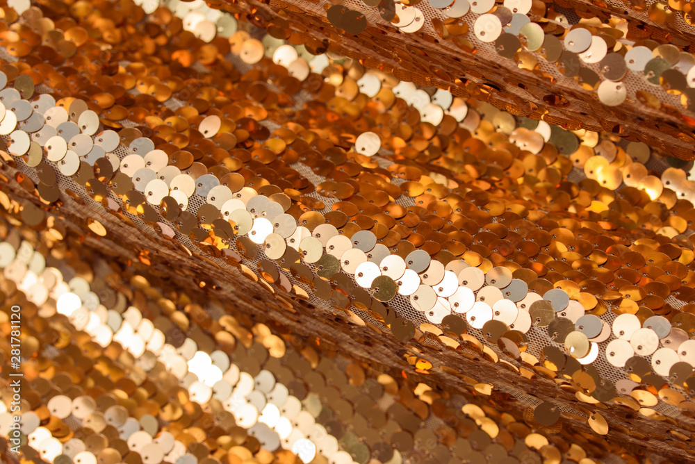 Golden fabric, sparkles, gold, texture, background. Festive background.