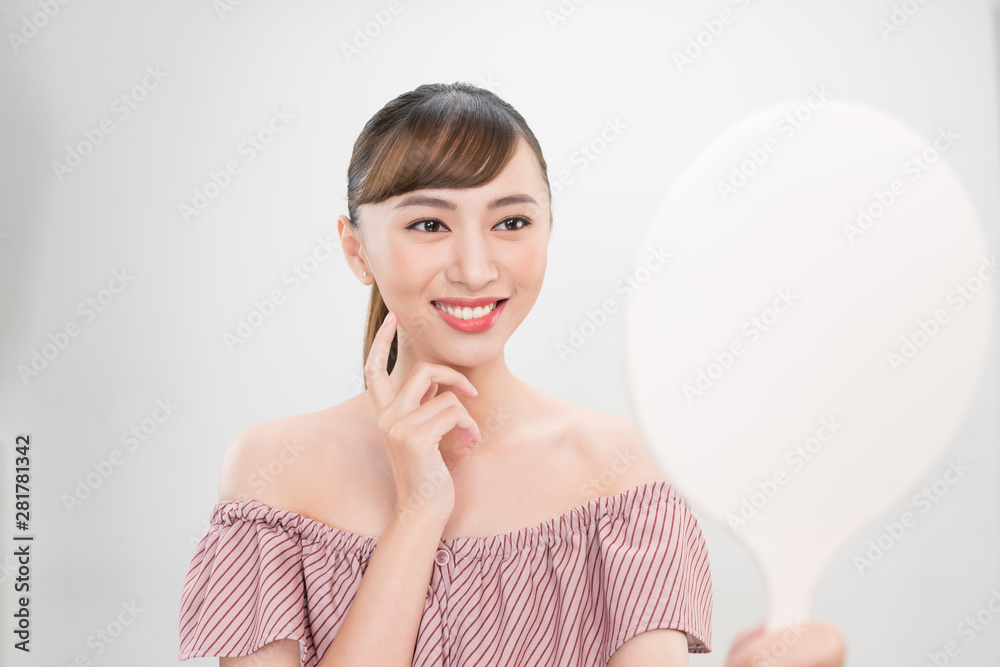 Beautiful smiling girl with natural makeup touching face. Beautiful smiling girl with natural makeup touching face.