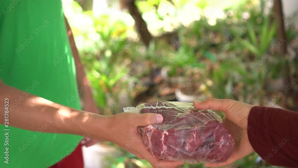 Stockvideon Muslim volunteer distribute meat slaughtered during Eid