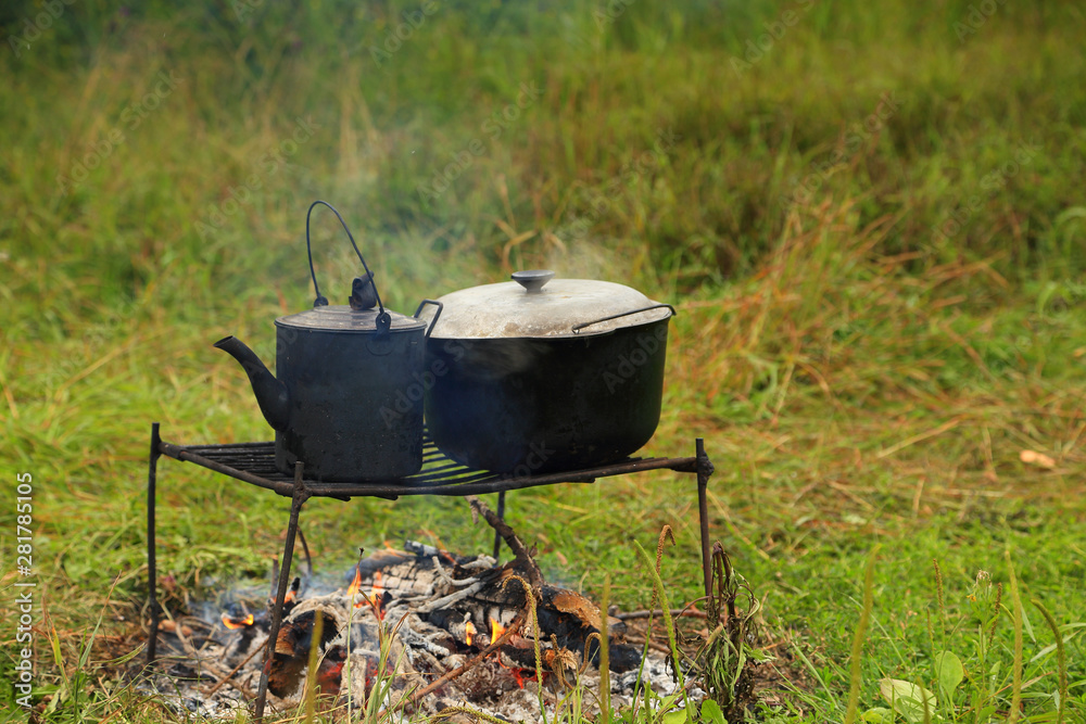 Real tourism, preparing tea and food on a fire during a hike, in the wild. Real tourism, preparing tea and food on a fire during a hike, in the wild.