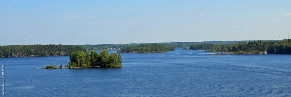 Panorama view to lake Saimaa with small island. Many wind power stations on background. Location: Luukkaansalmi bridge, Lappeenranta, Finland