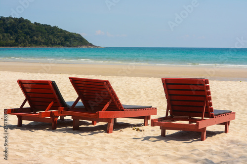 Fototapeta Naklejka Na Ścianę i Meble -  Wooden lounge chairs on beautiful tropical beaches.
