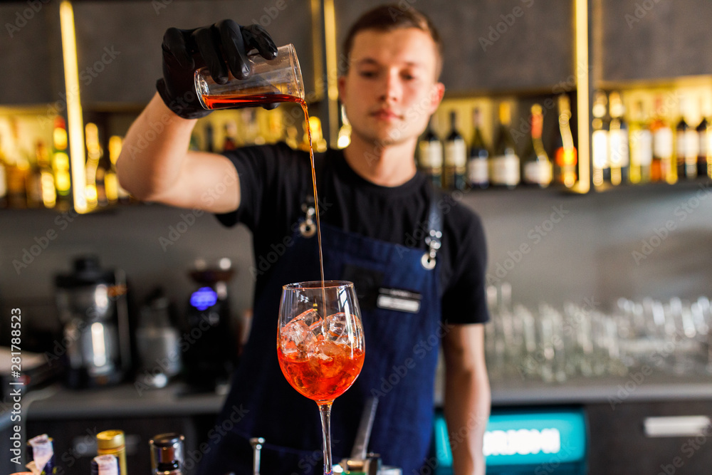 barman make a cocktail in a restaurant