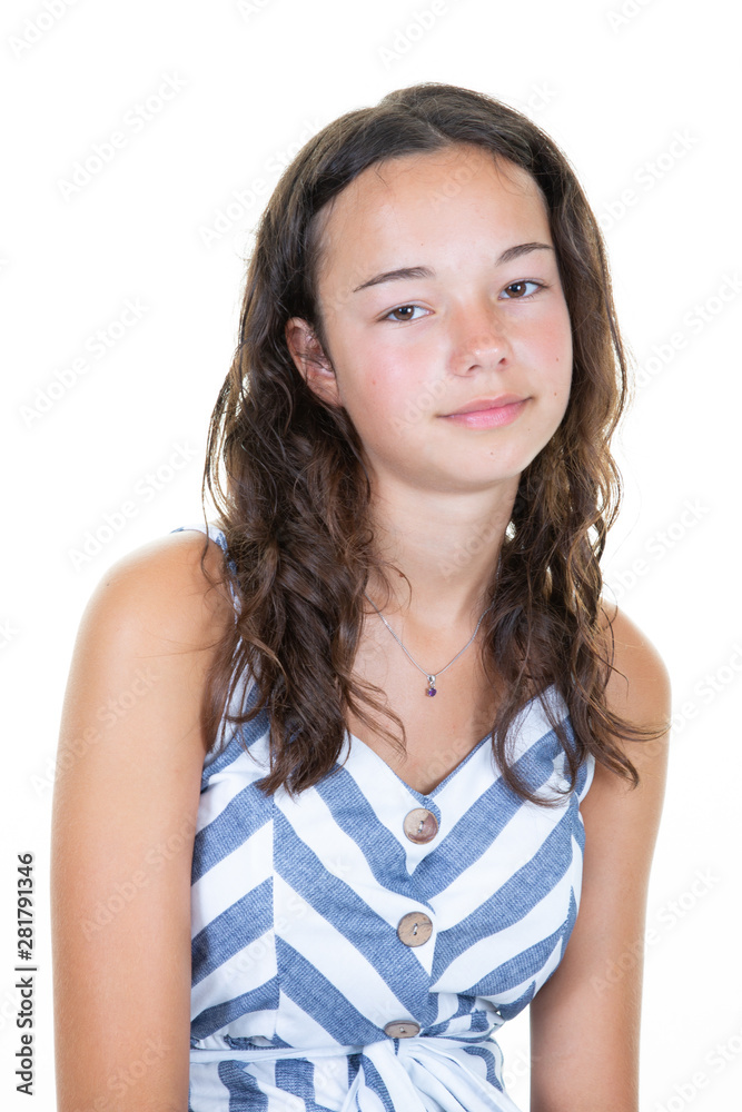 Portrait of young caucasian woman in blue white dress casually standing near white wall in concept of being confident teenager Portrait of young caucasian woman in blue white dress casually standing near white wall in concept of being confident teenager