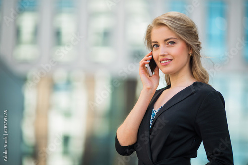 beautiful young woman in a suit calls on the phone