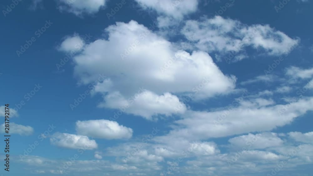 Timelapse of white clouds flowing against blue sky on sunny day Timelapse of white clouds flowing against blue sky on sunny day