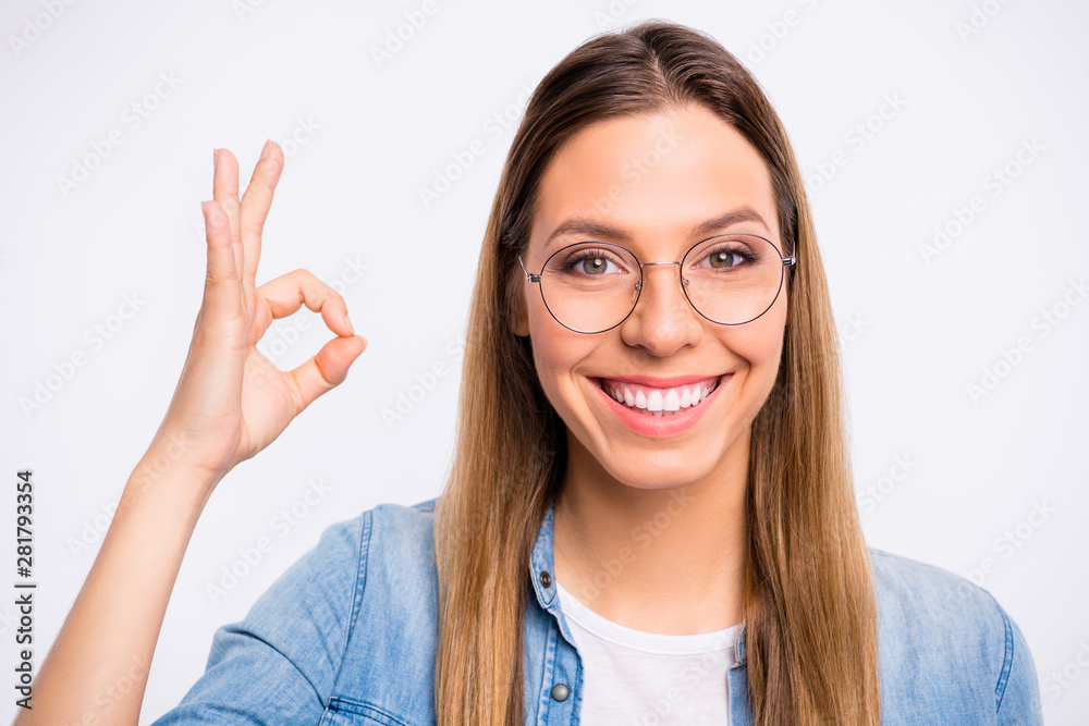 Closeup photo of cheerful pretty with shiny beaming straight teeth lady giving okey symbol isolated grey background Closeup photo of cheerful pretty with shiny beaming straight teeth lady giving okey symbol isolated grey background