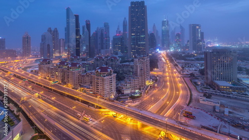 Dubai downtown skyline night to day aerial timelapse with traffic on highway