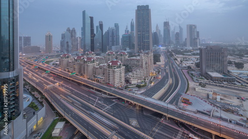 Dubai downtown skyline night to day aerial timelapse with traffic on highway