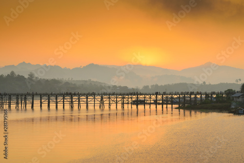 Landscape of the wooden bridge in the morning during the sunrise. The Mon Bridge at Sangkhla Buri District Kanchanaburi Province, Thailand. © MrSathit