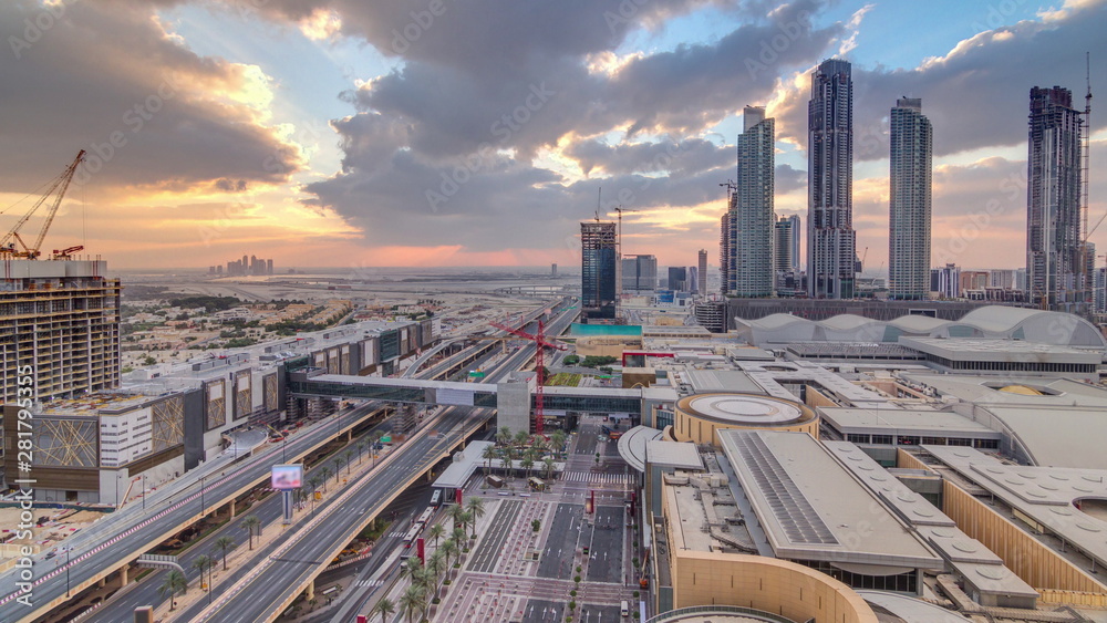 Obraz premium Sunrise aerial view of Financial center road morning timelapse with under construction building