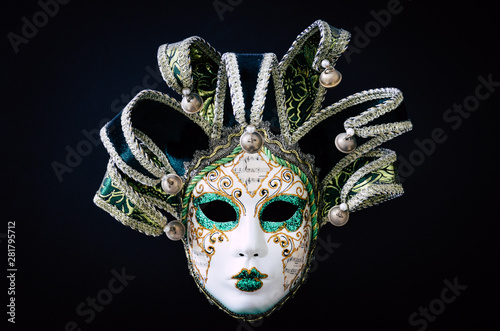 Venetian carnival mask isolated on black background. Traditional carnival in Venice. Green and white mask with glitters. Masquerade party. Mardi Gras, costumes. Concept, abstract