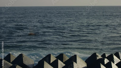 Slow motion of peaceful sea and breakwaters photo