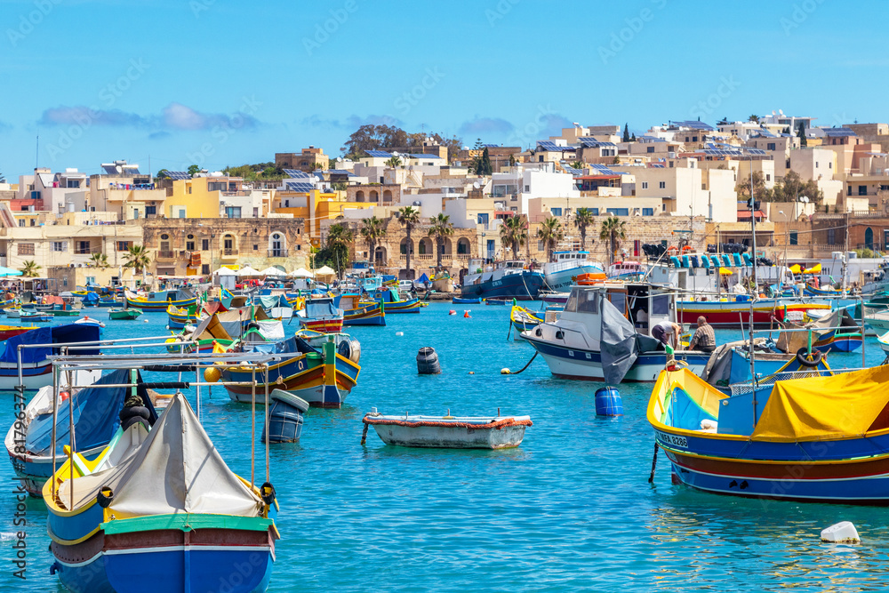 The traditional eyed boats in the harbor of fishing village Marsaxlokk in Malta
