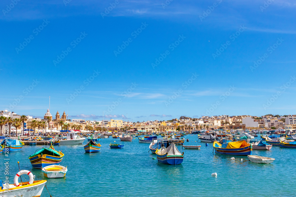 The traditional eyed boats in the harbor of fishing village Marsaxlokk in Malta