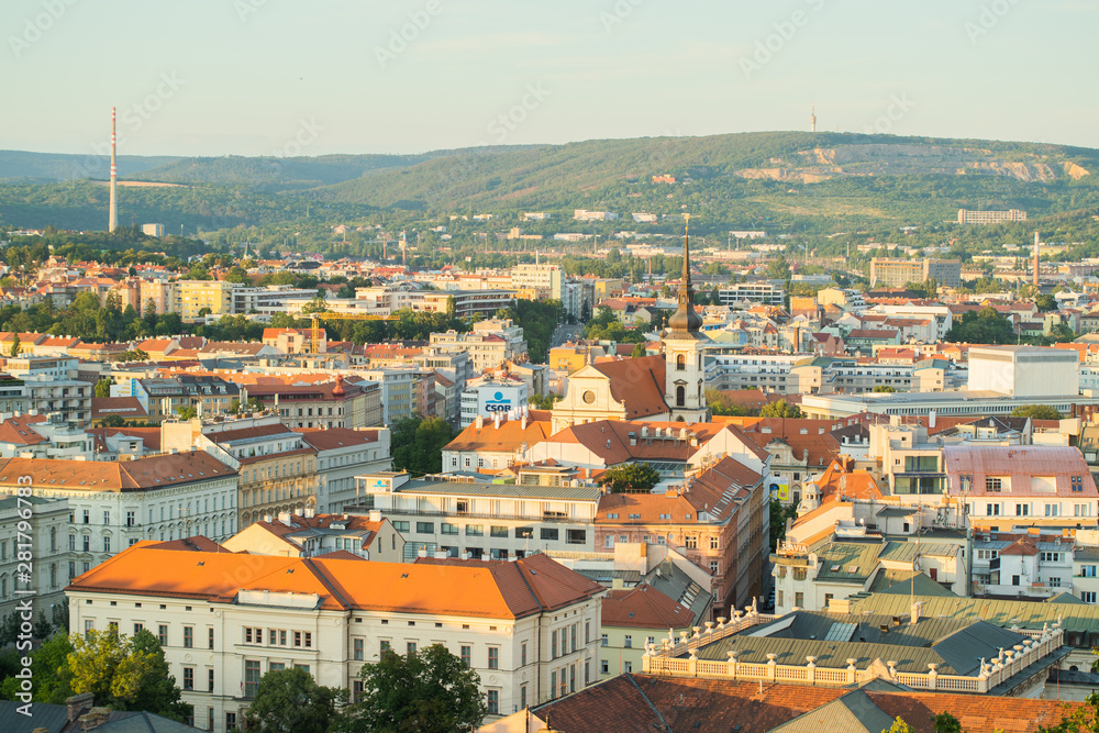 Fototapeta premium View of the center of Brno Czech Republic houses church and street captured from the height of the walls of Spilberk Castle during sunset in summer time.