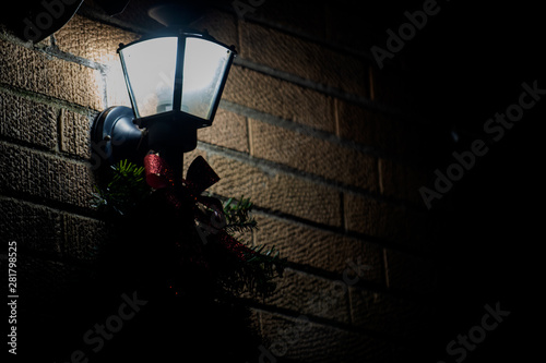 Vintage old style street light Lantern at night with Christmas decorations. Winter Holidays Tradition.