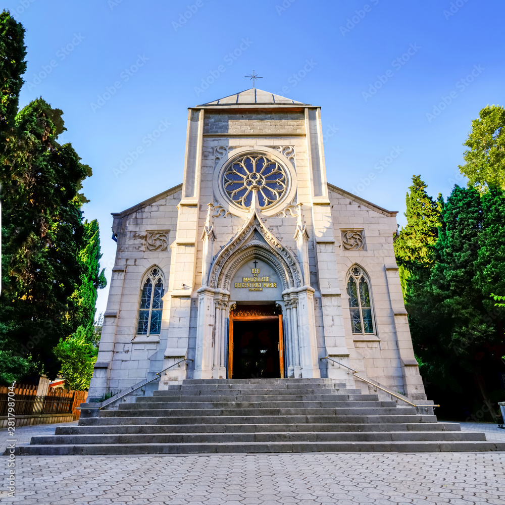 view of the facade of the Church of the Immaculate conception in Yalta photo from tourist street